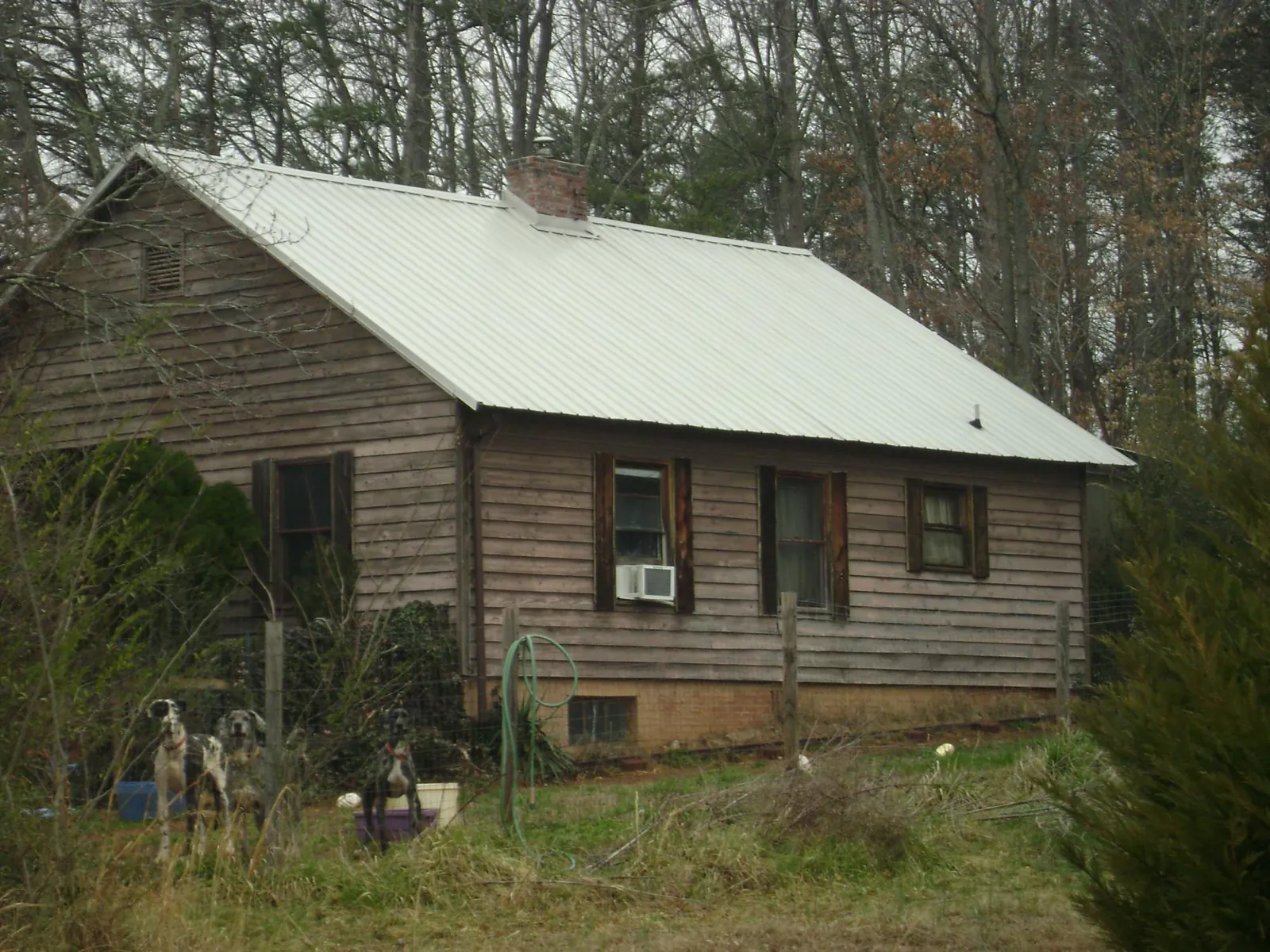 White metal roof on an old wood sided farmhouse, from a Metal Roof Installation job in Bentonia